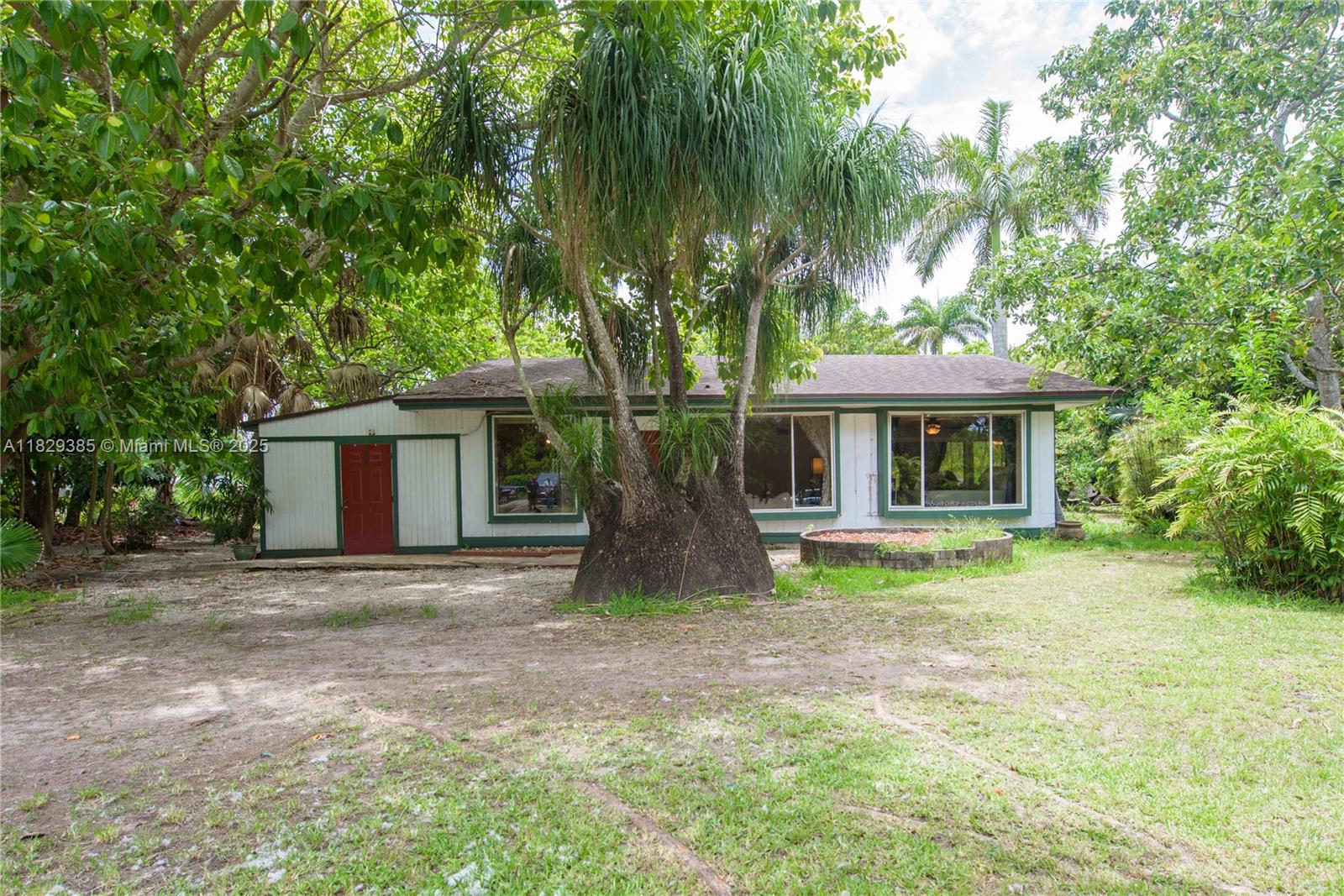 Charming Home on .62 Acres – A Tropical Oasis! This beautiful property offers 3 bedrooms and 2 baths, tile floors, a bright dining room with chandelier, and a master with mirrored wall, wall-to-wall closet, and ensuite bath/shower. Includes in-law quarters with kitchenette, ideal for guests or rental. Laundry room with washer/dryer and outdoor access. The lush yard features avocado, mango, longan, eggfruit, and sapodilla trees, plus a shed. A perfect blend of indoor comfort and outdoor charm! PROOF OF FUNDS AND/OR PRE-APPROVAL LETTER REQUIRED PRIOR TO SCHEDULING A SHOWING OF THE PROPERTY!