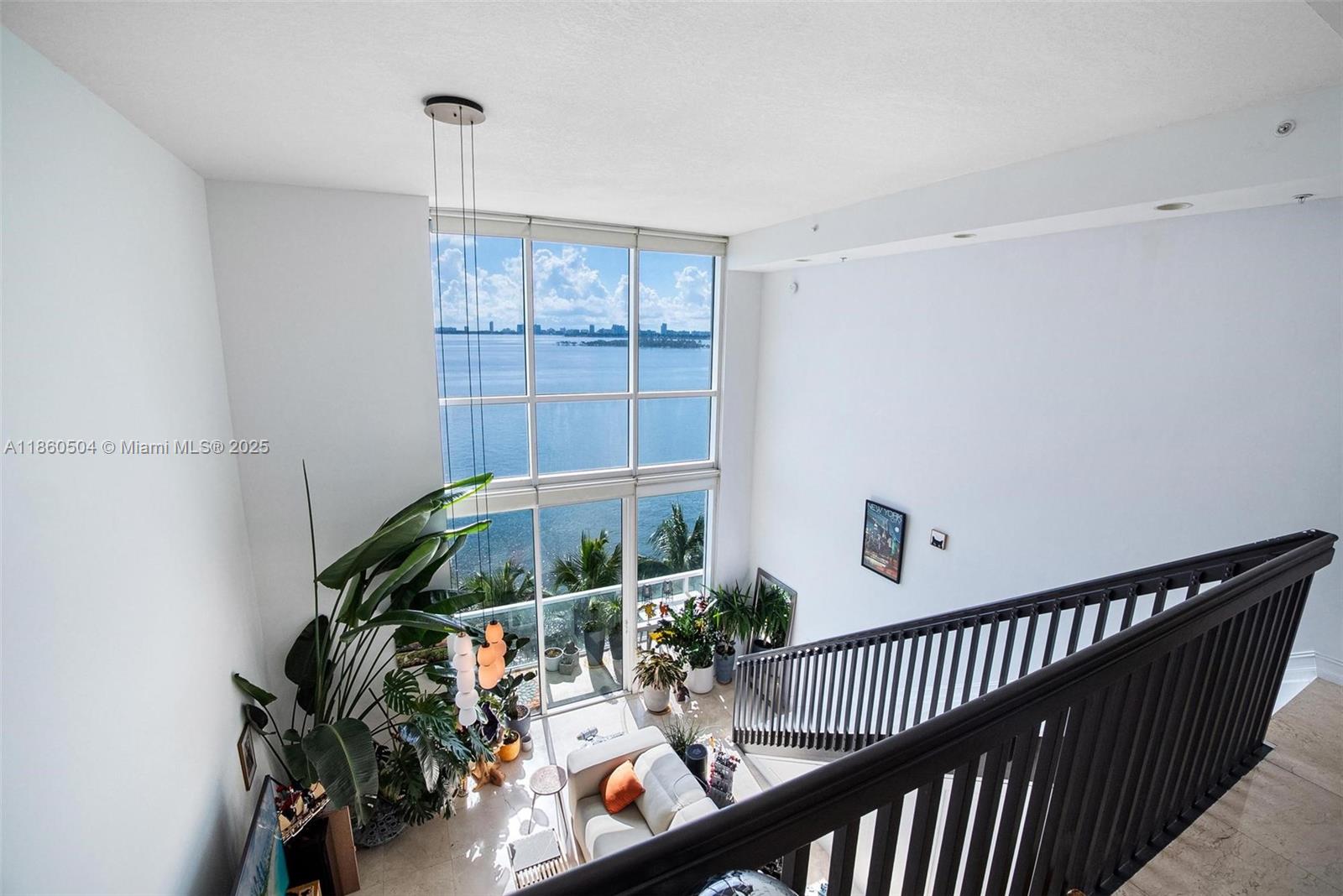 Discover this exquisite RARE two-story bayfront loft in Edgewater, featuring unobstructed Biscayne Bay and Ocean views. This meticulously maintained boutique building offers upscale amenities, including an infinity-edge pool, gym, steam room, spa, and concierge service, along with a pet area and BBQ grills on the 8th floor. Inside, the unit boasts over $100,000 in upgrades, including a gourmet kitchen with granite countertops and sun-filled living spaces with floor-to-ceiling windows. The open master bedroom overlooks the bay, providing a serene retreat.Conveniently located near shops and restaurants, including Whole Foods Market and Margaret Pace Park, this loft is a short drive from Midtown, Wynwood, and the Design District. Walkers Paradise
