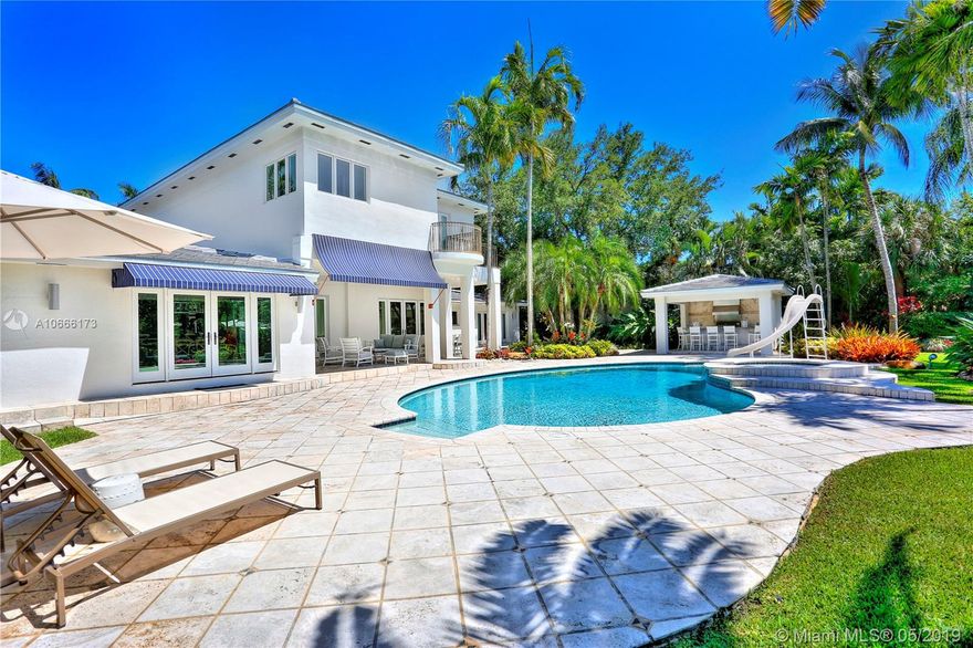 Spectacular waterfront home, turnkey, located on prestigious Riviera Drive in Coral Gables. No expense has been spared. The long list starts with a new roof, impact windows and doors, generator to power the entire house, and luxurious bathrooms. This home has an excellent flow with spacious rooms. Private upstairs master with additional master on 1st floor. It lends itself to entertaining hundreds, as well as intimate gatherings. Open floor plan draws you to the outdoor patio where you enter the garden remodeled summer kitchen. Wide canal and 85’ dock.