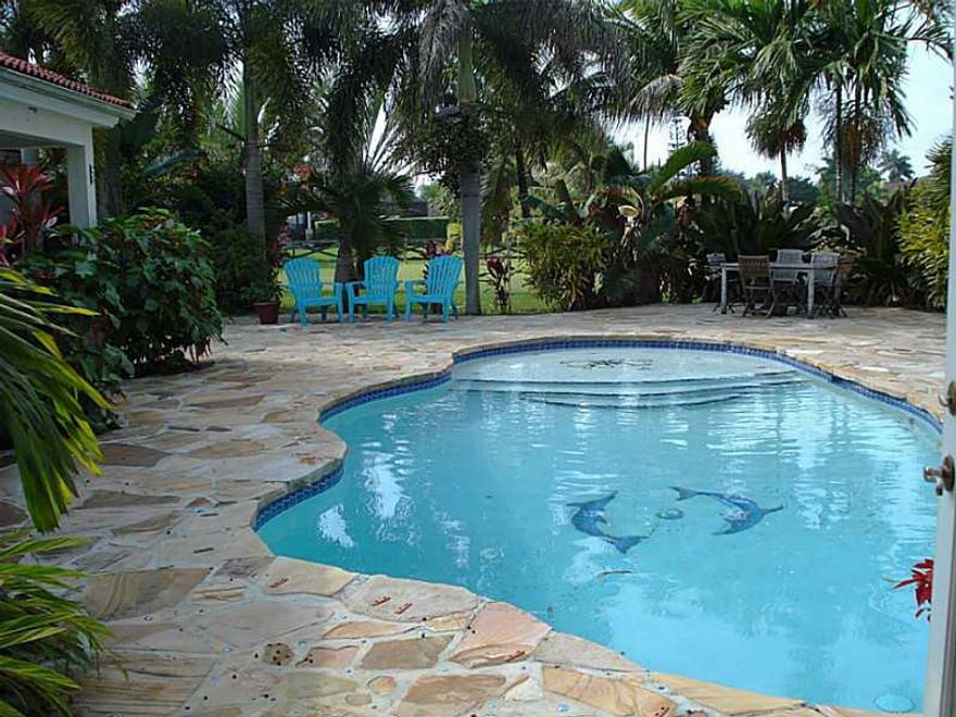 Artist owned tropical beauty with resort style pool area, metal roofed gazebo, and plenty of room for your family! Easy flow floorplan featuring great room, vaulted ceilings, skylights, island kitchen w/desk, french doors and pantry. One bedroom has it's  own bath and lg walk in closet. The huge romantic master has french doors and vaulted ceiling, 2 walk ins plus linen closet. Special finan available .Buyer must pre qual with City1st mtg broker.