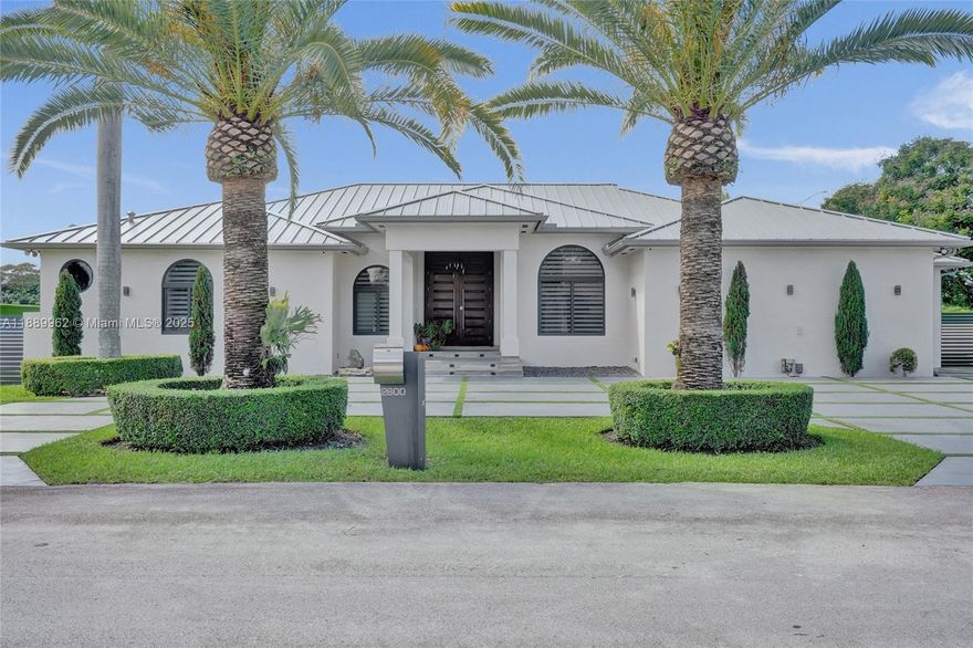 Fully renovated modern home blending luxury style, elegant design, and advanced engineering. This one-story residence offers porcelain floors throughout, hardwood in bedrooms, spacious family and dining rooms, plus a formal living area. Gourmet kitchen with Sub-Zero/Wolf appliances and granite countertops opens to expansive entertaining spaces. Master suite features his/hers walk-in closets, dual sinks, and large shower with dual rainfall heads. Resort-style patio with marble pool deck, Jacuzzi, covered terraces, summer kitchen, and guesthouse. Additional highlights include new metal roof, impact windows and doors, powered blinds, circular driveway, and private cul-de-sac location