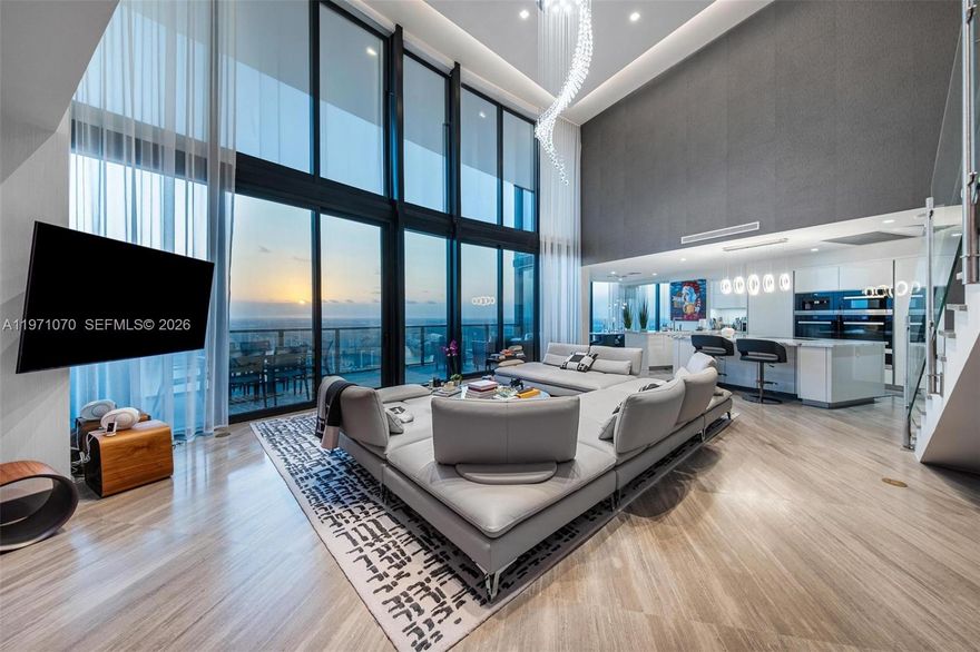 Experience elevated luxuries in this one of a kind Duplex in the sky, Residence 5003, boasting over 22ft ceilings soaring into the sky, this is a rare gem in which few are available, Meticulously finished, this turnkey 3 bedroom plus Den, 4.5 bathrooms home in the sky, has been designed with Roche Bobois, custom pieces, throughout the home, including Ornare costom  closets, wall finishes, and detailed lighting, all  in the Iconic Porsche Design Tower. This  sky residence has unparalleled views which never end, with expansive living room space & entertaining space, a secondary area perfect as a family room, the flow is like a custom home,  each bedroom features its own en-suite bathroom and custom closet. Private elevator entry and you have your own internal elevator which leads to the 2nd level with 22ft ceilings, floor-to-ceiling glass sweeping panoramic views Intracoastal, city, bay and downtown Miami skyline, includes and outdoor space with a gourmet kitchen. The signature car elevator delivers your vehicle directly to your private garage in the sky. Expansive terraces, a summer kitchen, seamless indoor-outdoor living. Enjoy a sleek open kitchen with Miele appliances and refined finishes, plus access to world-class amenities: restaurant, beach service, spa, car lounge, clubroom, yoga & fitness center, with white glove service from our onsite concierge.  Live your Dream today ! Miami at its best!