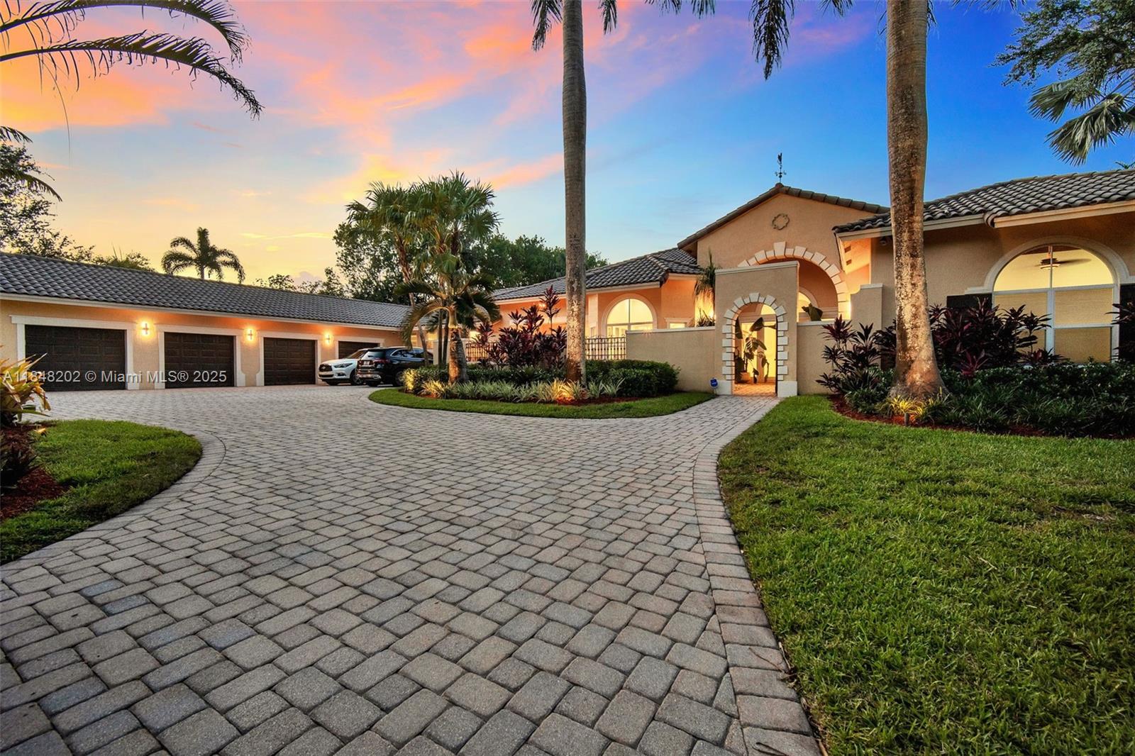 Gated 2.7 acre estate in exclusive Sunshine Ranches offering unmatched privacy, space, and tropical luxury. This 7 bedroom, 6.5 bath hacienda style residence (including a den) also features a separate office, wood and tile flooring, crown molding, and generous living areas filled with natural light. The fully fenced grounds are a true tropical paradise professionally landscaped with over $300K in mature palms, exotic plants, and fruit trees, plus over $20K in custom outdoor lighting. Outdoor highlights include an expansive travertine deck, scenic walking trails, and a tiki hut overlooking a serene private lagoon. Additional features include a 4 car garage, whole house generator, 500 gallon underground propane tank, and security cameras. A rare find in prestigious Southwest Ranches.