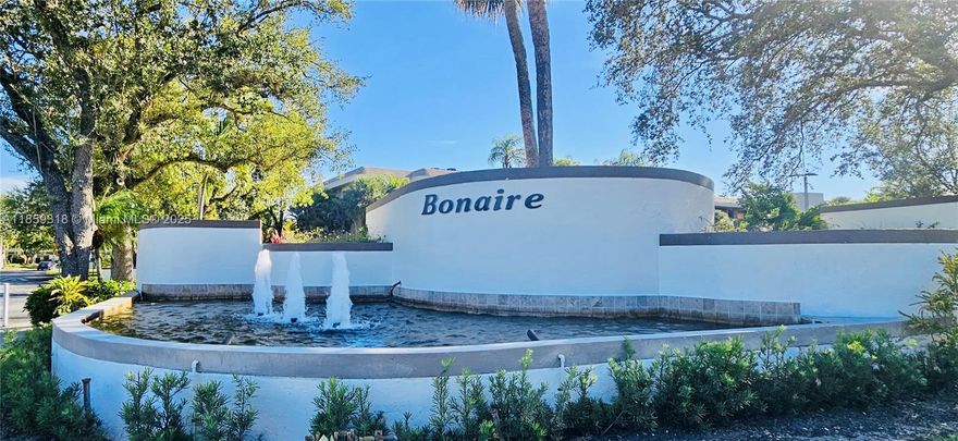 Step into a home that feels as good as it looks. This light-filled 2-bedroom, 2-bath corner unit in the gated, all-age community of Bonaire at Woodmont offers just under 1,500 sq ft of stylish comfort. Sunlight streams through impact windows, highlighting the tile floors, designer kitchen with stainless steel appliances and beautifully updated bathrooms. Custom-fitted closets add a touch of elegance and exceptional organization, while dual screened patios create inviting spaces to enjoy morning coffee or evening breezes. A private laundry room and smart layout make everyday living easy. Perfectly situated minutes from shopping, dining and A-rated schools, this turn-key home is ready to welcome you.