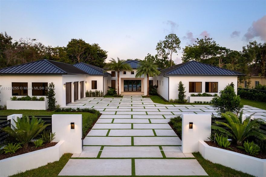 Discover a 2024-built tropical oasis situated on an expansive 39,814 SqFt lot. Inside, Italian porcelain tiles extend throughout, while large impact glass windows fill the home with natural light & showcase picturesque views of the lush landscape. The kitchen fts. fully integrated Miele appliances, 10’ Italian custom cabinetry & durable porcelain countertops. Recessed LED lighting elegantly accents the cabinetry, while a wine cellar completes this chef’s haven. The primary ste offers a peaceful retreat with a private office or sitting area, direct pool access, & a spacious walk-in closet illuminated by LED lighting. Step into a backyard paradise surrounded by lush green artificial turf, showcasing a sparkling pool with an adjoining hot tub & a versatile court for Pickleball and basketball.