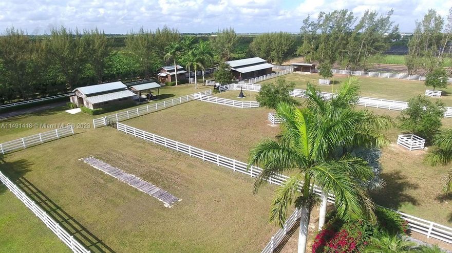 stunning 10 acre equestrian facility. its a 1st class set up.. includes center aisle birthing stable, covered arena w chandeliers, raised seating, multiple barns 3/2 home w wrap around screen porch, detached 25x 45 a/c gym, 5 acres of pasture land, stadium lights, tiki, flight cages, chicken coop, 4 board fencing , hot walker. etc. a GREAT event facility, limited neighbors on a paved road in prime redland. THIS IS A MUST SEE...