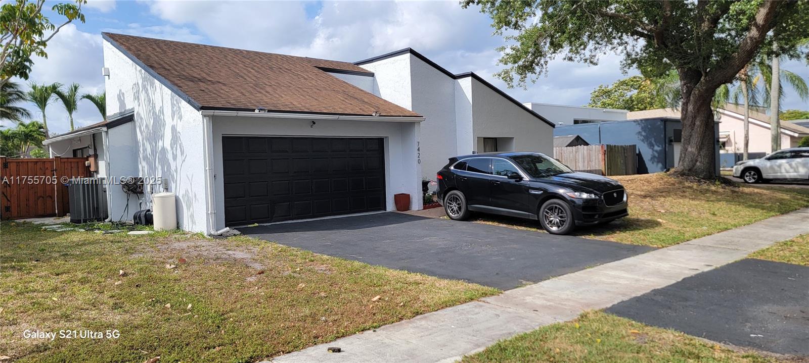 Your Dream house . Don't miss this updated 3 huge Bedroom 2 full bath with a real 2 car garage with AC already installed ,side door and a window if you needed to expand its all done for you. The Pool with spa is nothing but breathe taking . Area to plant your Garden ready to go a must see, 7 Ft fence . Hot tube to relaxing and watch the game. 12ft ceiling spacious totally fenced with gate on both side. Florida room with built in TV can view from the Hot tube of pool. Tesla charger Installed.