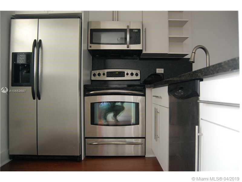 Beautiful remodeled unit tiled floors central air , assigned parking.