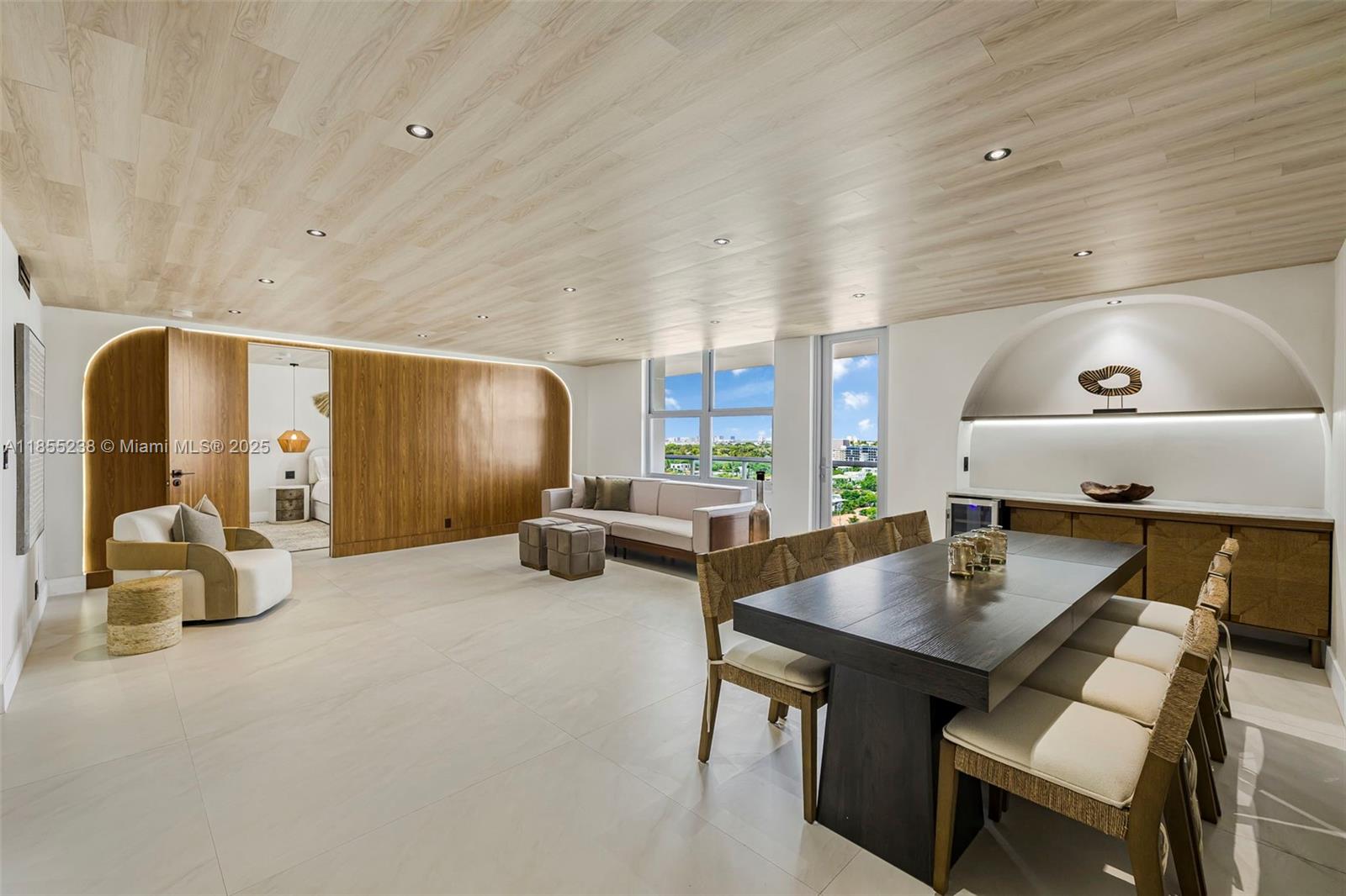 Welcome to Residence 1209 at Surfside Towers, a fully renovated 2-bedroom plus den condo on the 12th floor offering modern elegance and stunning skyline views. This bright, open-concept home features custom wood-paneled ceilings and walls, recessed lighting, and large-format tile flooring throughout. The living and dining areas flow into a sleek built-in kitchen with custom cabinetry and integrated lighting. The versatile den is ideal for a home office or guest space, while both bedrooms offer comfort and tranquility. With a neutral palette, refined finishes, and abundant natural light, this residence is move-in ready. Enjoy full-service beachfront living with direct beach access, pool, gym, and close proximity to Bal Harbour Shops and the Four Seasons Surf Club. Beach Service & Pool Open.