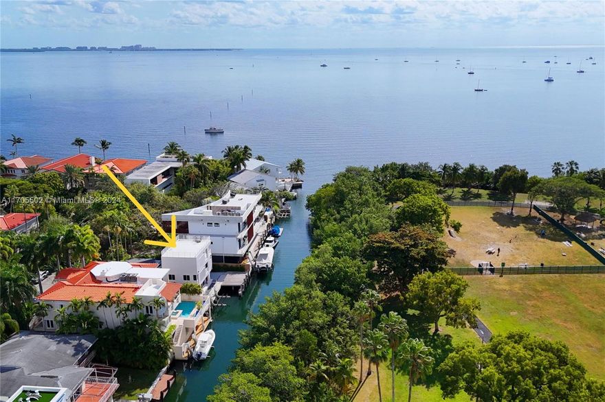 With no bridges to the Bay, this newly-renovated home on exclusive Rockerman Road is a boater’s paradise w/ 6 BRs & 4.5 BAs spanning 3,517 SF on a 7,053 SF lot w/ 61’ on the water.  The open kitchen features new appliances & freshly-painted cabinets.  The living & dining areas have lovely views of the water & Kennedy Park across the way.  There are also 2 BRs w/ en-suite baths on the 1st floor, 1 of which could be the primary suite.  The primary suite is located privately on the 3rd floor & includes 2 walk-in closets, BA w/ dual vanities, & separate tub & shower.  The 4th level rooftop terrace enjoys gorgeous vistas! New roof, new impact glass windows & doors, new seawall & dock w/ lift, renovated BAs, easy bay access, all conveniently close to downtown Coconut Grove & downtown Miami!