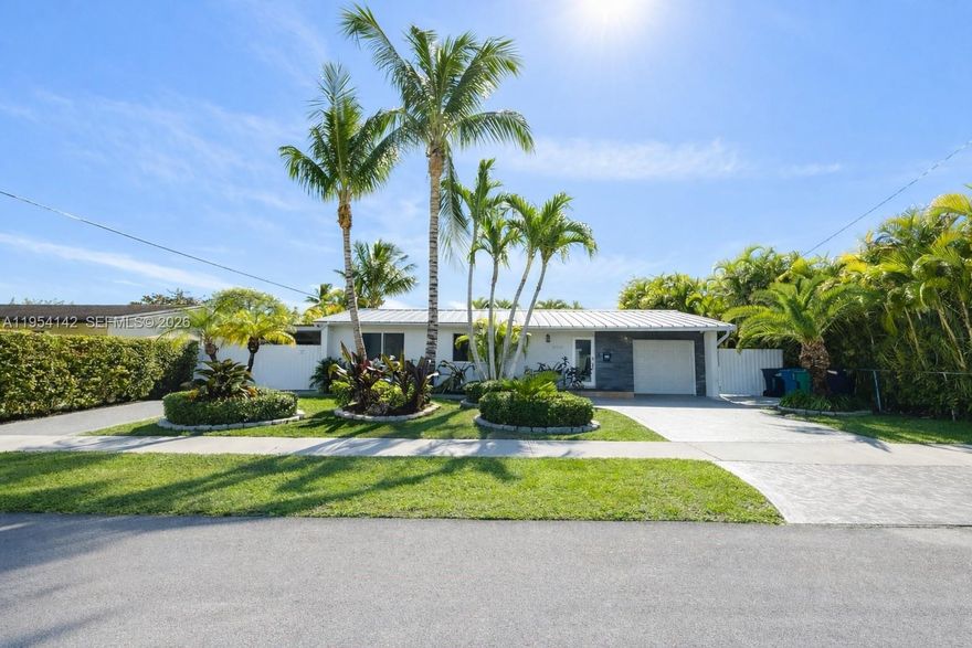 NEW 2026 Metal roof and impact windows. Beautifully updated and freshly painted single-family home featuring impact windows and doors throughout, a whole-house generator, and elegant travertine tile floors flowing seamlessly across the living areas and bathrooms. This home offers two master bedrooms, each with modern finishes and glass shower doors. The kitchen and baths boast sleek quartz countertops, complemented by LED lighting that brightens every space. Enjoy a blend of comfort, efficiency, and timeless style — ready to move in and perfectly suited for modern living.