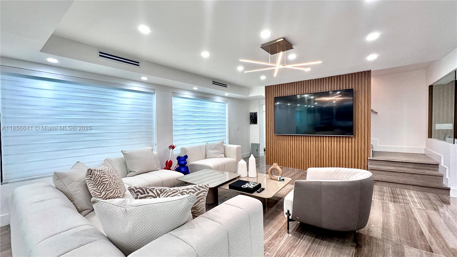 Modern masterpiece nestled on over an acre of lush, tropical grounds in the heart of Aventura. Fully renovated with no expense spared, this furnished 5-bed, 5-bath residence (4 full baths plus 1 half) spans 3,185?s?ft and features hand-selected Italian designer furniture, spectacular contemporary bathrooms, and the finest marble finishes throughout. Mature oak trees offer serene privacy and a tranquil canopy that feels miles from the city. Just minutes from top-rated schools, beaches, and within walking distance to places of worship, this one-of-a-kind gem delivers luxury, exclusivity, and convenience.