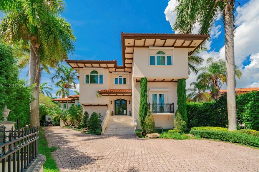 Beautiful 5,818 Sq.Ft waterfront residence with 5 bedrooms and 5 1/2 baths in the coveted Cocoplum gated community. Combining Mediterranean revival style with Spanish and Italian elements, this waterfront home is nestled on a tree-lined cul-de-sac with meticulous landscaping, tall palm trees, a classic entryway and spacious driveway. The elegant floor plan features marble floors, stone pillars and light-filled living spaces ideal for entertaining and comfortable living. The gourmet kitchen has top-of-the-line appliances, center island and a breakfast area. The grounds behind the house feature a covered terrace, sparkling pool and a private new 60 Ft. dock. A media room, 2-car garage, generator, laundry and staff room complete this tranquil retreat, close to schools, restaurants and shops.