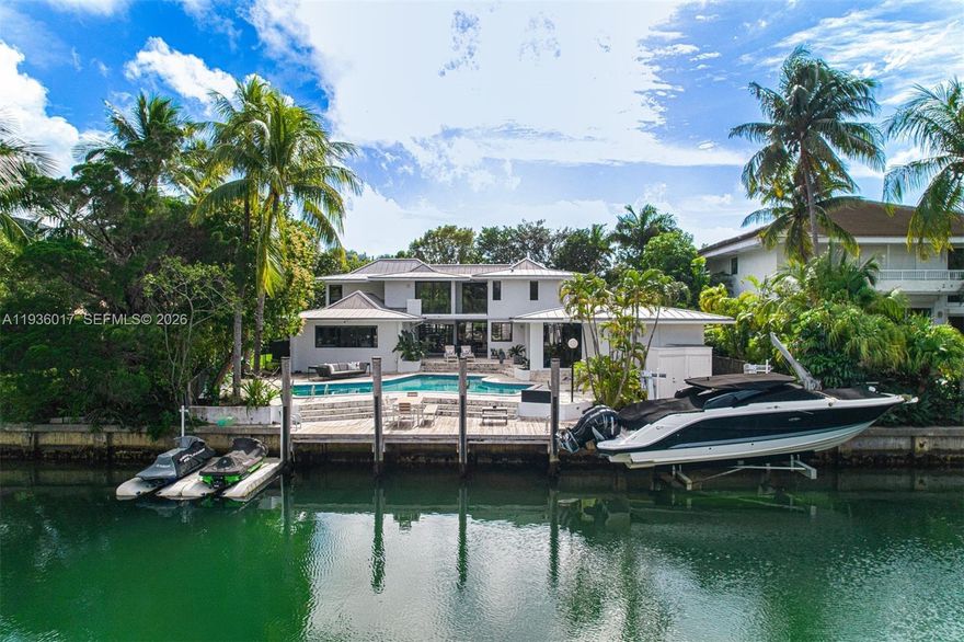 Designed for those who value privacy, space, and a true connection to the water, this exceptional waterfront residence offers a rare boater’s retreat and a warm, inviting setting for family living. Tucked away on a quiet street and set on an expansive nearly 14,000-square-foot lot, the home impresses from the moment you arrive with its generous front yard and gated entry, offering both presence and privacy. Inside, a bright two-story layout unfolds with an open, airy feel, thoughtfully designed for both everyday comfort entertaining. The residence features five bedrooms, four full bathrooms, plus a cabana bath, all flowing seamlessly enhanced by abundant natural light and tranquil water views. Renovated in 2019, the home includes impact windows and doors, a beautifully updated kitchen and appliances, lighting throughout, gas generator, and a pool heater and chiller for year-round enjoyment. The outdoor living experience is truly exceptional…enjoy direct water access with a private dock, boat lift, and two dry jet-ski docks, allowing you to step straight from your backyard to open water and fully embrace the waterfront lifestyle. A detached, enclosed two-car garage adds versatility, while the gated property offers abundant parking for up to six vehicles, a rare and valuable amenity in Key Biscayne. Homes of this caliber which offer privacy, boating infrastructure, generous land, and modern upgrades are increasingly rare and best appreciated in person.