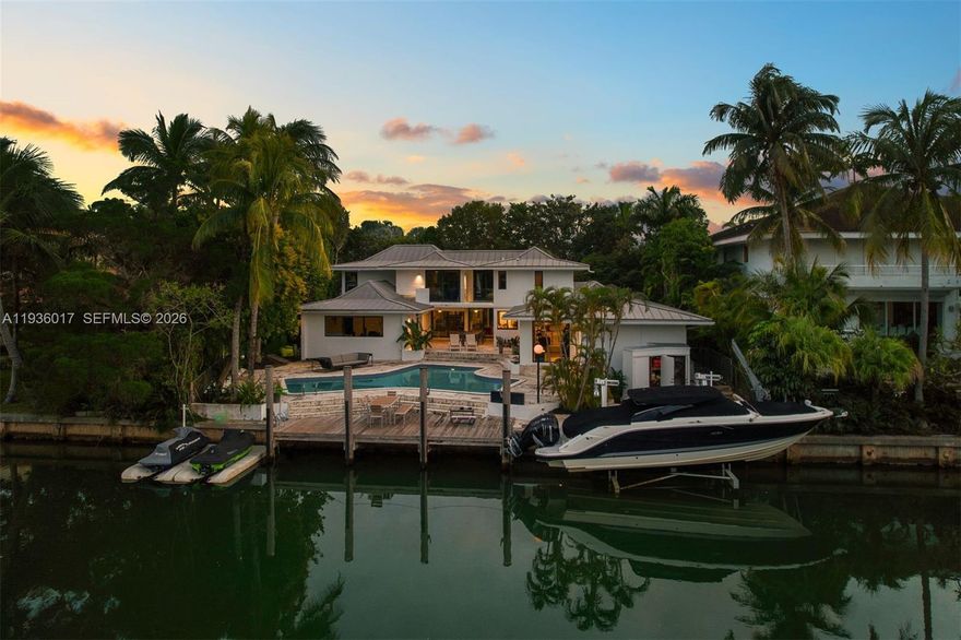 Designed for those who value privacy, space, and a true connection to the water, this exceptional waterfront residence offers a rare boater’s retreat and a warm, inviting setting for family living. Tucked away on a quiet street and set on an expansive nearly 14,000-square-foot lot, the home impresses from the moment you arrive with its generous front yard and gated entry, offering both presence and privacy. Inside, a bright two-story layout unfolds with an open, airy feel, thoughtfully designed for both everyday comfort entertaining. The residence features five bedrooms, four full bathrooms, plus a cabana bath, all flowing seamlessly enhanced by abundant natural light and tranquil water views. Renovated in 2019, the home includes impact windows and doors, a beautifully updated kitchen and appliances, lighting throughout, gas generator, and a pool heater and chiller for year-round enjoyment. The outdoor living experience is truly exceptional…enjoy direct water access with a private dock, boat lift, and two dry jet-ski docks, allowing you to step straight from your backyard to open water and fully embrace the waterfront lifestyle. A detached, enclosed two-car garage adds versatility, while the gated property offers abundant parking for up to six vehicles, a rare and valuable amenity in Key Biscayne. Homes of this caliber which offer privacy, boating infrastructure, generous land, and modern upgrades are increasingly rare and best appreciated in person.