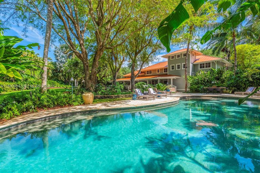 SIGNIFICANT PRICE ADJUSTMENT. Tucked within the exclusive gated community of Banyan Lakes, this custom estate exudes timeless Coral Gables elegance. Set on a breathtaking 50,000+ SF lot, the property is surrounded by majestic live oaks, manicured terraces, and a resort-style lagoon pool—creating a private, park-like retreat. Spanning 8,765 SF, this 6-bedroom, 5.2-bath residence is designed for gracious living and entertaining. The home features a formal living room opening to a serene Zen garden, family room w/ fireplace & custom built-ins, & chef’s kitchen with Wolfe & SubZero appliances, banquette seating, & butler’s pantry. The primary BR includes gym, 2 walk-in closets, & spa-like bath. Additional highlights include white oak floors, impact glass, metal roof, generator, & 2-car garage.
