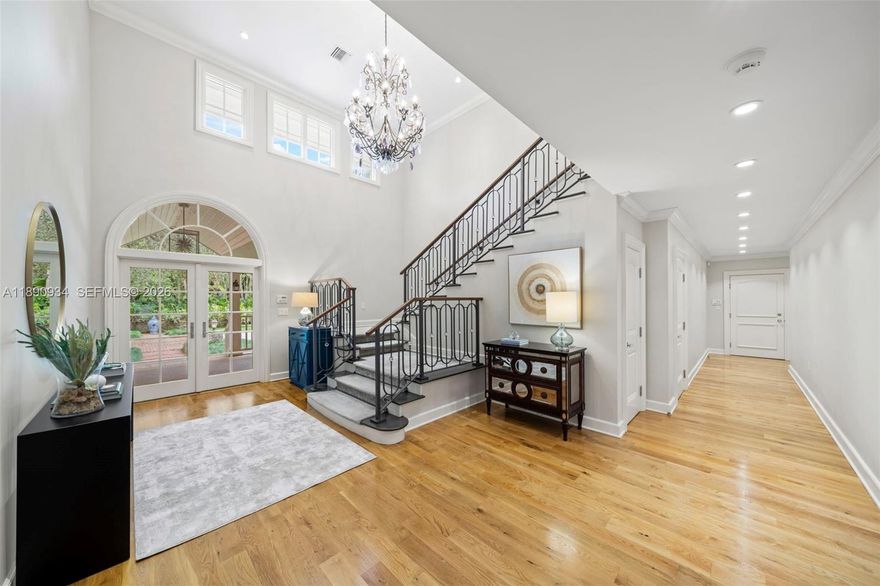 SIGNIFICANT PRICE ADJUSTMENT. Tucked within the exclusive gated community of Banyan Lakes, this custom estate exudes timeless Coral Gables elegance. Set on a breathtaking 50,000+ SF lot, the property is surrounded by majestic live oaks, manicured terraces, and a resort-style lagoon pool—creating a private, park-like retreat. Spanning 8,765 SF, this 6-bedroom, 5.2-bath residence is designed for gracious living and entertaining. The home features a formal living room opening to a serene Zen garden, family room w/ fireplace & custom built-ins, & chef’s kitchen with Wolfe & SubZero appliances, banquette seating, & butler’s pantry. The primary BR includes gym, 2 walk-in closets, & spa-like bath. Additional highlights include white oak floors, impact glass, metal roof, generator, & 2-car garage.