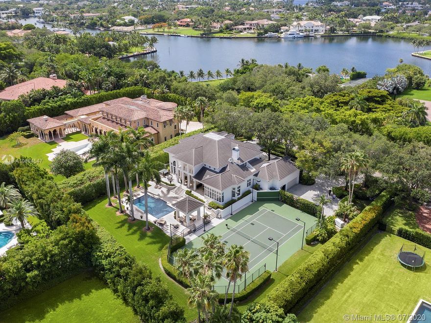 Within the secure confines of renowned Gables Estates sits this Architectural Masterpiece. The finest of contemporary finishes and a flowing floor plan featuring three staircases sets this home apart. Recently updated with new roof, heated pool and spa bathrooms. Gleaming marble floors a polished mahogany bar and built-ins combine to make this a perfect home for family and entertaining. The downstairs master retreat features 20’ ceilings, separate his and her closets and bathrooms with a steam shower. Towering French doors lead to the estates grounds. Elevated terraces guide you to a stunning heated pool, spa and a lit tennis court. Executive office, gym and media room in addition to 6 spacious on suite bedrooms. Featured in Florida Architecture. A generational Opportunity for your family.