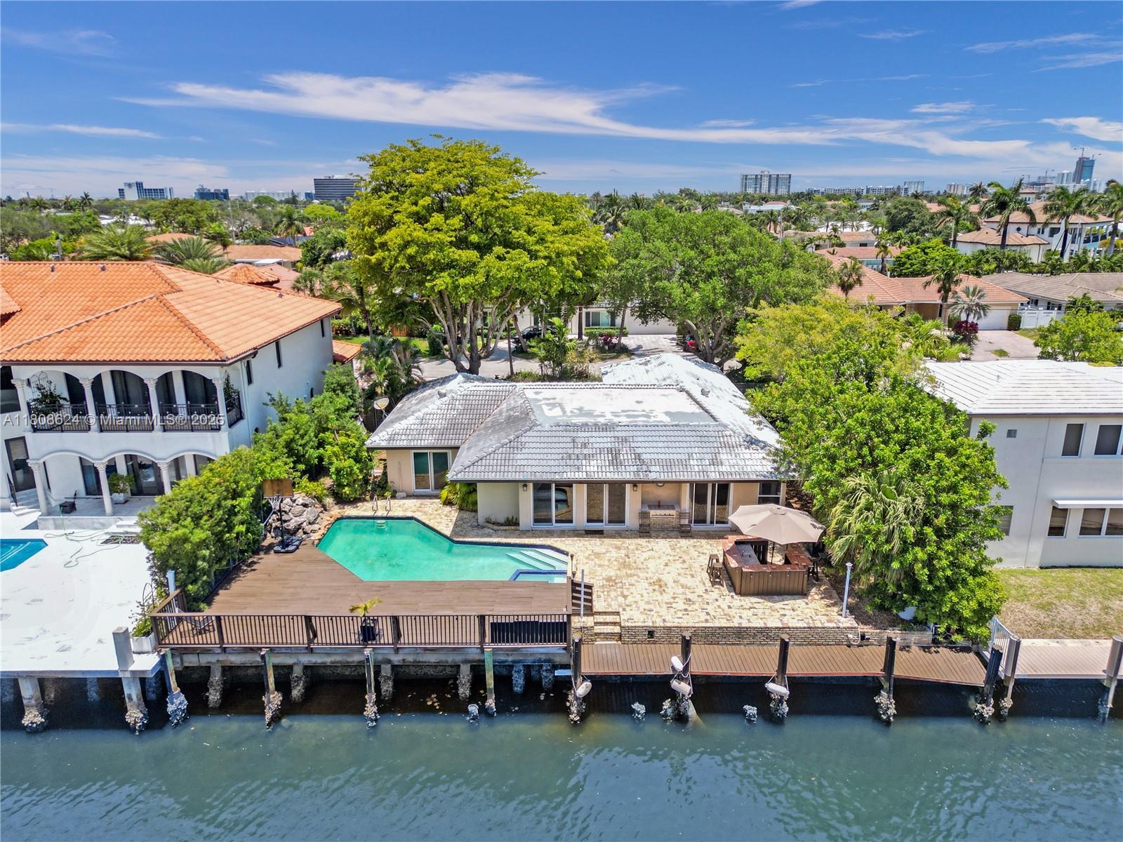Waterfront Paradise for Boat Lovers! Dock your yacht right in your backyard—80+ ft of deep water frontage with no fixed bridges and direct ocean access. Skip traffic and cruise to nearby waterfront restaurants. Enjoy a spacious open floor plan, hurricane-impact windows, and stunning views. Gourmet kitchen, pro gas stove, stylish baths, walk-in closet, travertine living floors, tile in bedrooms. Relax in a large pool (2–6 ft depth), spa, wood deck, shaded tiki, and grill area. Located on a quiet street, you’re just a short walk to the beach, dining, and entertainment. Located only 5 minutes to top-rated public and private schools, including the prestigious Pinecrest School. Live the ultimate South Florida lifestyle with luxury, convenience and comfort.