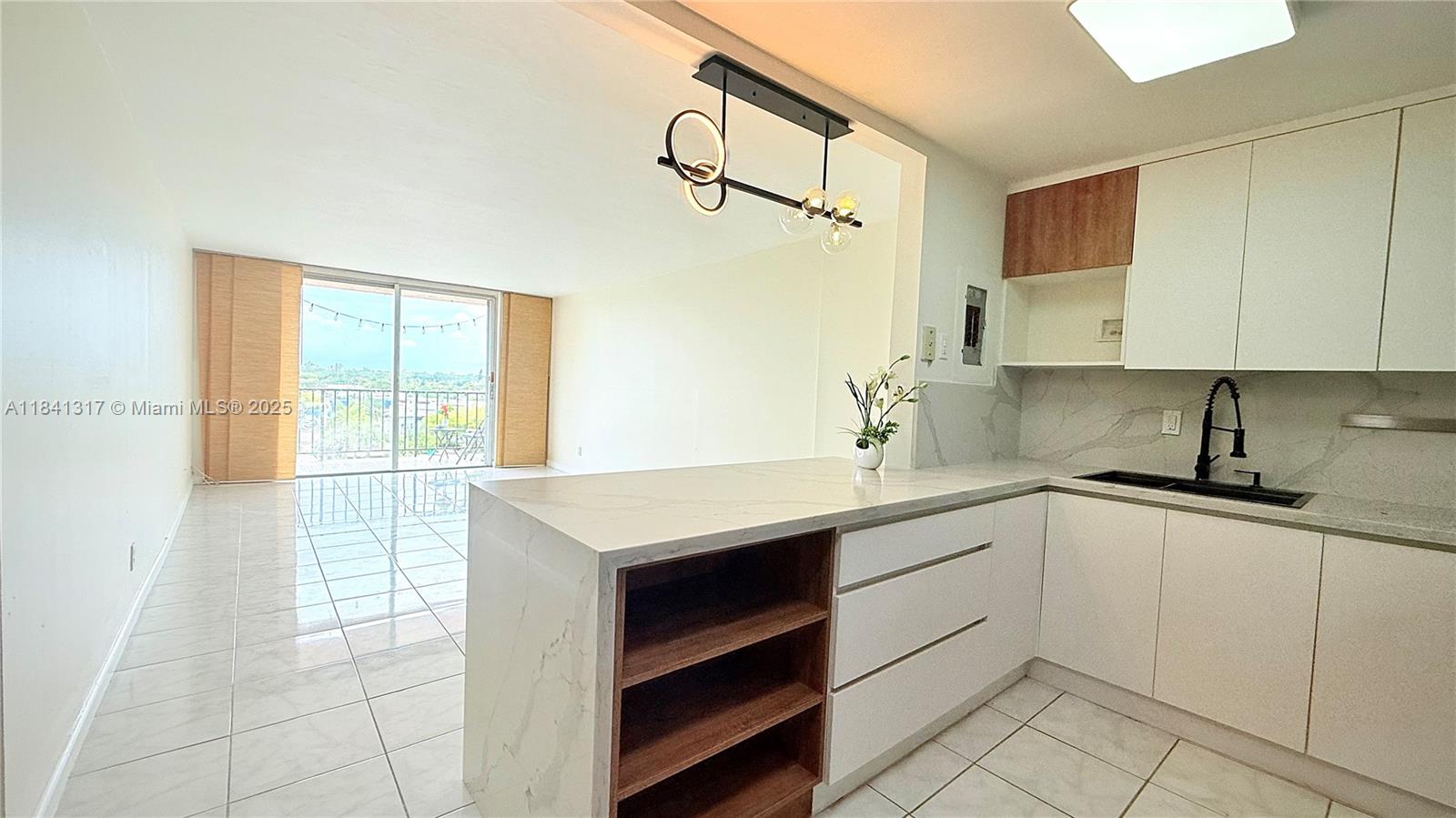Enjoy a bright, open-concept living space with tile flooring, a modern kitchen featuring quartz countertops, custom cabinetry, and black stainless steel appliances. The bathroom has been elegantly renovated with a glass-enclosed shower, gold fixtures, and stylish finishes. Rent Includes: Water/Hot water, garbage, 1 assigned parking space, and 1 storage. Gated building with secured entry and community pool. Centrally located near FIU, Barry University, Whole Foods, shops, beaches, and major highways.