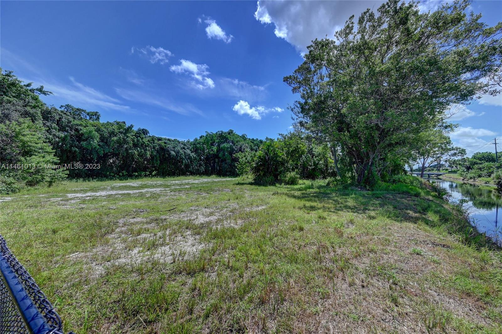 ATTENTION DEVELOPERS!! 1.29-acre vacant lot in Delray Beach with private deeded access by Woodland Drive behind a gated and private community and with 338 ft of canal/waterfront. The lot recently had a single-family home demolished back in 2020. It has all available utilities and is ready to be developed for a large home. The lot is surrounded by a canal and lots of beautiful trees. Very private, will not last as it is priced to sell. Please see important information on broker remarks. This is a cash sale only and will be sold via auction.