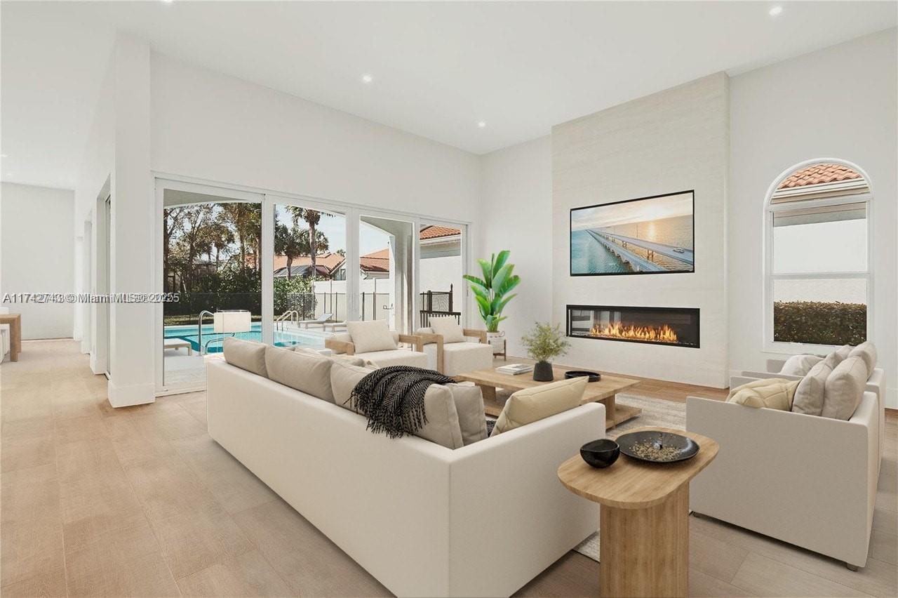 DISCOVER YOUR NEW COASTAL HAVEN! Thoughtfully curated renovation with custom cabinetry and the most sought after Taj Mahal Quartzite countertop in all areas. The living space BOASTS volume ceilings, new wood tile flooring, & a custom built-in TV and electric fireplace. You will enjoy plenty of natural light with BRAND NEW IMPACT WINDOWS & DOORS, expansive to the HEATED & SALT WATER pool. This home is situated on an OVERSIZED lot for Jonathan's Landing with ALL NEW LANDSCAPING in the front & rear yard. Each bedroom is fully equipped with a CUSTOM WALK-IN CLOSET. ALL NEW bathroom tile, fixtures, shower glass, interior doors. NEWER AC, GENERATOR, HOT WATER IN 2021. This home has been so tastefully designed BY INTERIOR DESIGNER, with hand picked Serena & Lilly lighting throughout.