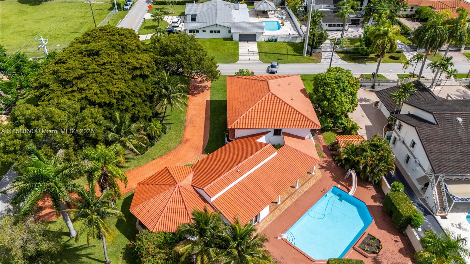 A once in a generation opportunity: this executive home is ready for you to fall in love. Nestled on a lushly landscaped 20,000 sf corner lot, a circular driveway greets your guests to the double door entry. Inside, you'll find room to entertain + host the entire family + friends with almost 5000sf under air (3 zone AC). Oversized family room opens to air-conditioned Florida room with sauna and cabana bath. Throw open 3 sets of french doors to the covered lanai. Entertain by the heated, salt-water pool in the outdoor kitchen. Back inside, there is a 1st floor bedroom suite , eat-in kitchen, home office, 1 car garage, formal living and dining rooms, and walls of glass overlooking your land. 4 beds,4 baths upstairs including massive primary suite w/ 2 walk-ins. 2024 roof to keep you dry