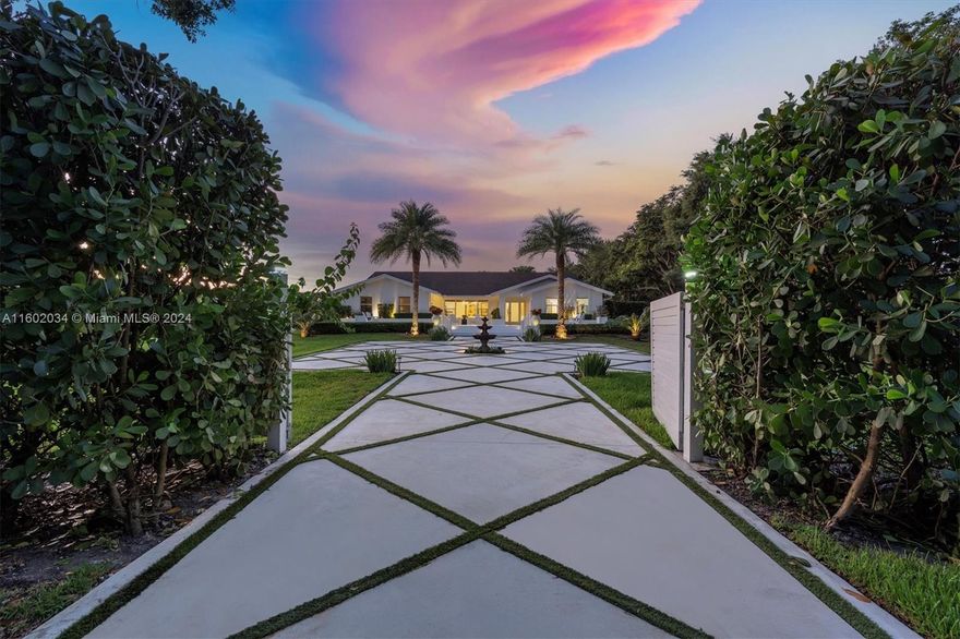 Welcome to one of the finest grand estates with a separate guest home. Enter through the gates and be whisked away to your own secluded oasis. This perfect home on over an acre features an open floor plan connecting formal living, family, dining, and kitchen areas. The chef's kitchen is a masterpiece with a Thermador 6-burner gas stove/griddle, double oven, wine fridge, and quartzite natural stone countertops. Newer roof, impact windows & doors, with each home offering a two-car garage. The guest home, with a separate entry, offers 2 beds/1 bath, a family room, & full kitchen. Enjoy a serene & private atmosphere w/ stunning landscaping that creates a zen-like ambience that is truly unmatched. Prime location 15 miles from Ft. Lauderdale & airport, near highways, beaches, dining, & shops.