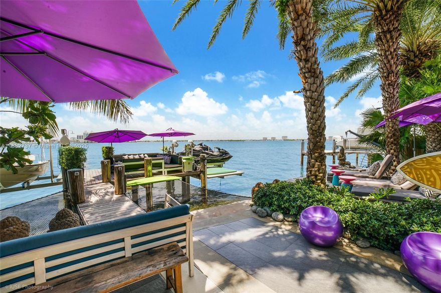 One-of-a-kind waterfront masterpiece! This unique home sits on a cul-de-sac on Normandy Shores exclusive gated community, w/ Normandy Shores Golf Club, Tennis, Basketball Courts, and Parks. Nestled on the Island's Terrace, shares w/only 6 residences breathtaking open bay views and sunsets. Built in 2015, this 3,442 SQ FT eccentric home features 4 bed/4 bath, open living and dining, state-of-the-art kitchen, and more. The home's Zen vibe begins as you step through a bamboo garden, 30 ft interior waterfall, and end at the open bay sanctuary. The backyard landscaping, shimmering pool, outdoor kitchen, and terraces make this home magic. Bath in the outdoor tub, watch movies at the two-story Tiki Hut, and enjoy the dock at sunset. Boat and Jet Ski lifts and davit. Plans for a two-car garage.