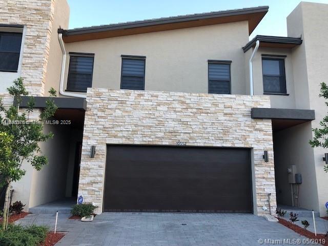 Spectacular 3/2.5 townhouse in Park Central at Doral. Tile on the first floor and modern laminate on the second floor. Huge master bedroom with bath and walk-in closet. 2-car garage. Large kitchen with plenty of prep space. Fully paved patio perfect for entertaining, kids to play, BBQs, and enjoying Miami weather. Premium lot with no neighbors behind. Take advantage of the brand-new clubhouse with resort-like amenities, waterpark for kids, amazing gym, sauna, and more! Window treatments throughout.