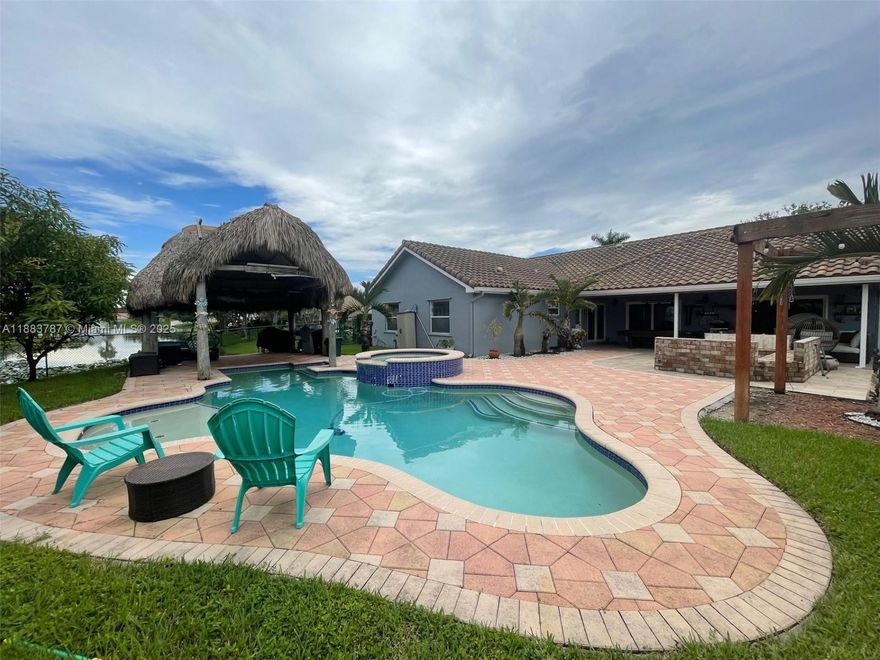 Beautifully maintained 4br/2.5 bth split floor plan on a very large and desirable corner lot. Home features huge front and back yard with a pool, tiki hut and fire pit area. Large tile through, open and remodeled kitchen with quartz counter tops, remodeled bathrooms, recently purchased appliances and washer and dryer in a separated room, vaulted ceilings and customs cabinetry. Great location to raise a family with excellent schools and easy highway access. 5 minutes away from Sawgrass Mills and plenty of restaurants in the area.