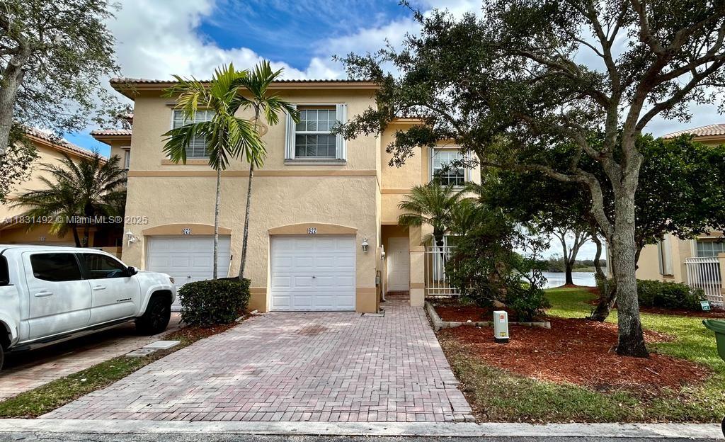 Welcome to paradise! This beautiful, and elegant townhouse (Currently the floor, kitchen and bathrooms are being remodeled), for rent is located in the prestigious and desirable Pembroke Isles Resort Gated Community. Prime Location, near A+ Schools, retail, grocery stores, entertainment, and medical facilities. This cozy home with a captivated breathtaking view to the lake has 3 beds and 2.5 baths, 1 car garage + 1 parking space, + guest parking av, + FULL SIZE washer/dryer. Tile downstairs and laminated wood floor upstairs; kitchen with new stainless steel appliances. The community offers lots of amenities including 3 pools, sauna, Jacuzzi, tennis, pickleball and basket courts, gym, beach Volley, soccer, playgrounds. 24 hrs security and NO HOA APPROVAL. Don't miss this opportunity.