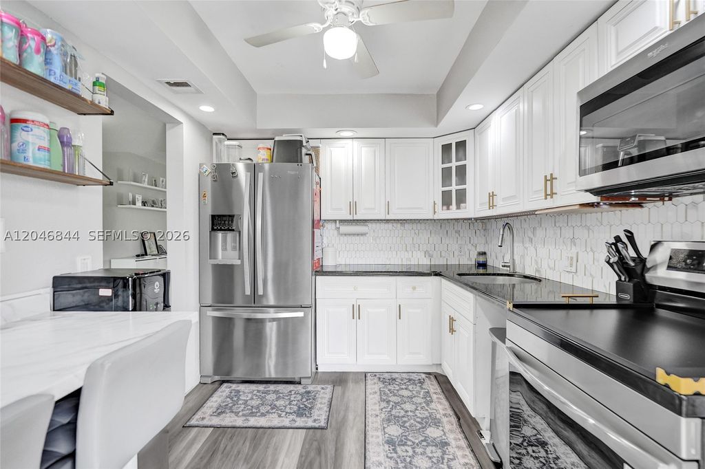 Photo of 2651 S Course Dr #410, Pompano Beach, FL 33069 (MLS # A12046844)