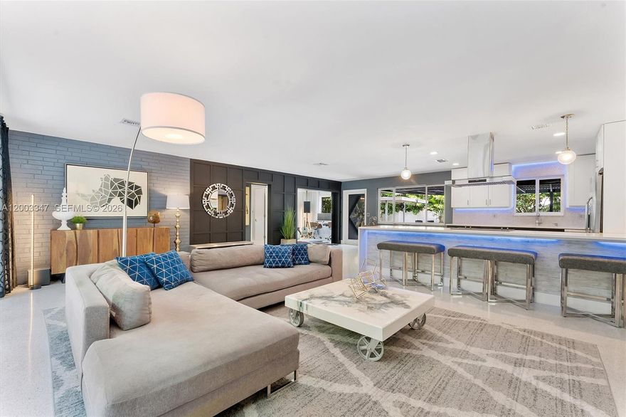 Stylishly reimagined 3BD/2BA residence in the sought-after Jenada Isles neighborhood of Wilton Manors, offering a seamless blend of design, functionality, and indoor-outdoor living. The open-concept layout centers around a fully updated kitchen with modern cabinetry, large island, and premium appliances, flowing effortlessly into expansive living and dining spaces.

Authentic terrazzo floors add character throughout, complemented by updated lighting and thoughtfully designed interiors. The split-bedroom layout provides privacy, while spacious rooms and ample storage enhance everyday livability.

Step outside to a true private retreat—featuring multiple lounge areas, a covered patio, outdoor dining space, and lush tropical landscaping. Plenty of room to entertain, relax, or customize further. Two-car garage and generous lot complete the offering.

Ideally located just minutes from Wilton Drive, beaches, and major thoroughfares. A turnkey property that delivers both lifestyle and design in one of Wilton Manors’ most desirable neighborhoods.