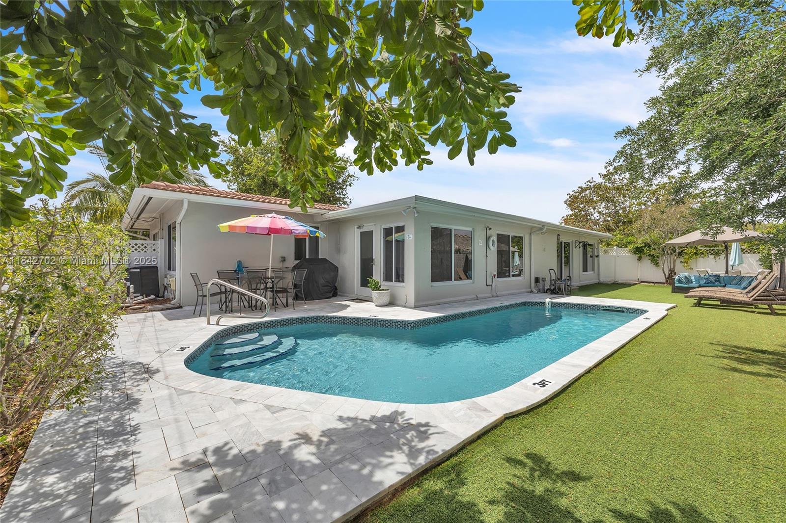 Short-term rental rates are higher with utilities included! ask for a quote, Renovated 4BR/2BA pool home in Connor Estates, North Pompano Beach, east of Federal Hwy 1. Features open kitchen with stainless appliances, indoor laundry, new porcelain floors, updated bathrooms, recessed lighting, and impact windows/doors. Enjoy a front porch, large driveway, carport, and fully fenced backyard with heated saltwater pool, artificial grass, outdoor seating, BBQ, and ambient lighting. Florida room overlooks the pool. Fully furnished, move-in ready. Available for sale, rent, or rent-to-own.