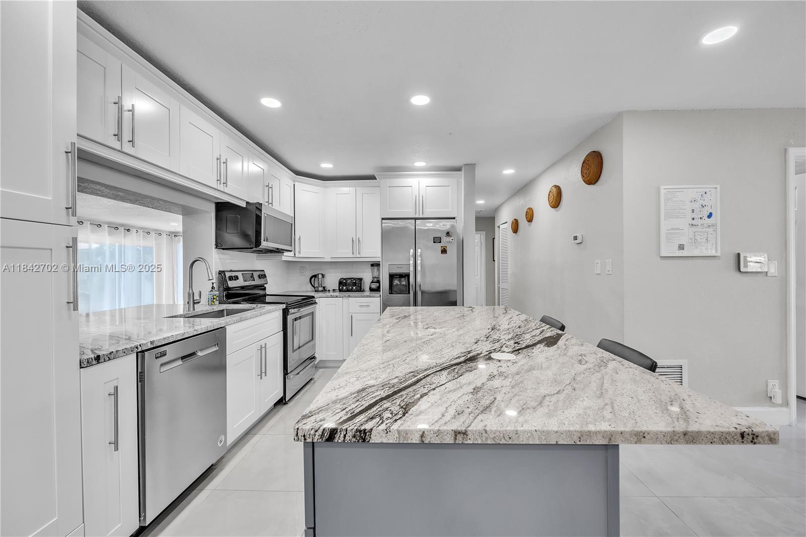 Beautifully renovated 4-bedroom, 2-bathroom pool home in the sought-after CONNOR ESTATES neighborhood of North Pompano Beach, EAST of Federal Hwy 1. This charming home features an open kitchen, indoor laundry, and a spacious layout. Enjoy a welcoming front porch, a large driveway, and a fully fenced backyard with a heated private saltwater pool. New porcelain floors, a solid wood kitchen with ss appliances, updated bathrooms, and recessed lighting. Impact windows and doors, central AC and heat, Florida room overlooking the pool. The backyard is designed for relaxation with artificial grass, an outdoor sitting area, BBQ space, and ambient lighting. Boat-friendly operating as a 5-star short-term rental. Fully furnished, move-in ready, with a carport. Available for sale/rent, or rent-to-own.