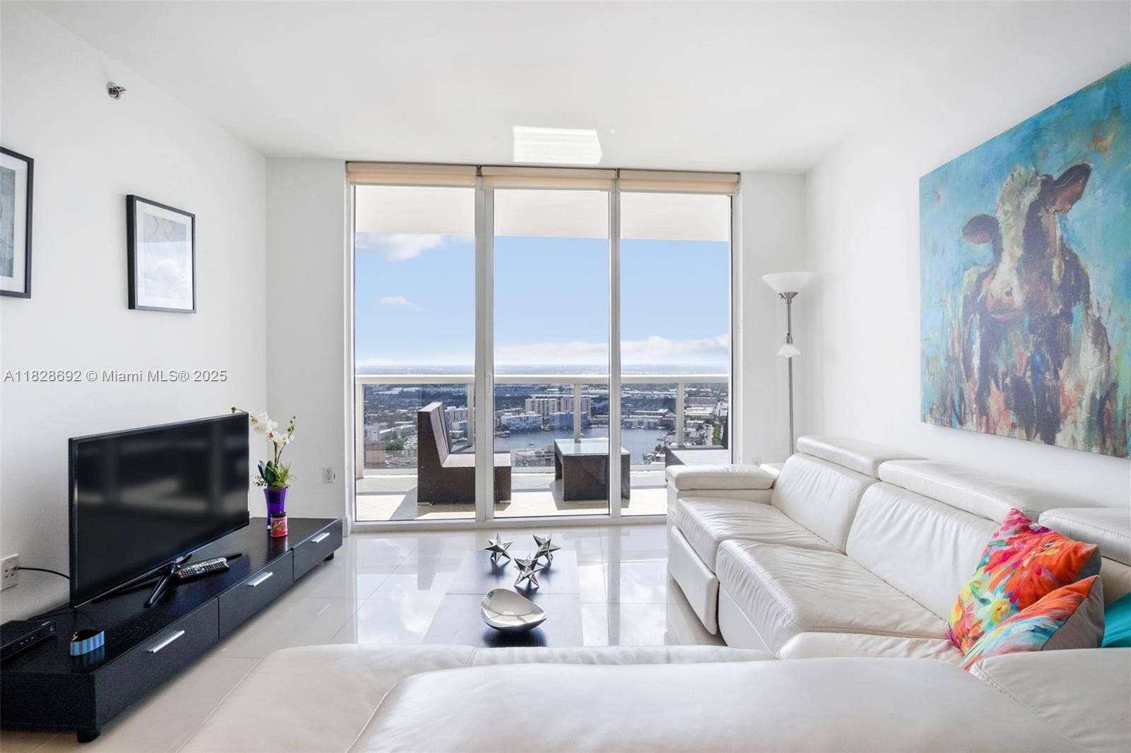 Experience stunning Intracoastal and city views from this spacious 1 bedroom + den / 1 bathroom residence. Offering 1,086 sq. ft. of interior space and an expansive 195 sq. ft. balcony, this unit features elegant marble floors and is located directly on the ocean. Enjoy resort-style living with access to a 40,000 sq. ft. full-service spa and fitness center, on-site restaurant and bar with poolside service, 24-hour valet parking, and security. The building sits on a 9-acre oceanfront property with 810 feet of direct beach frontage.