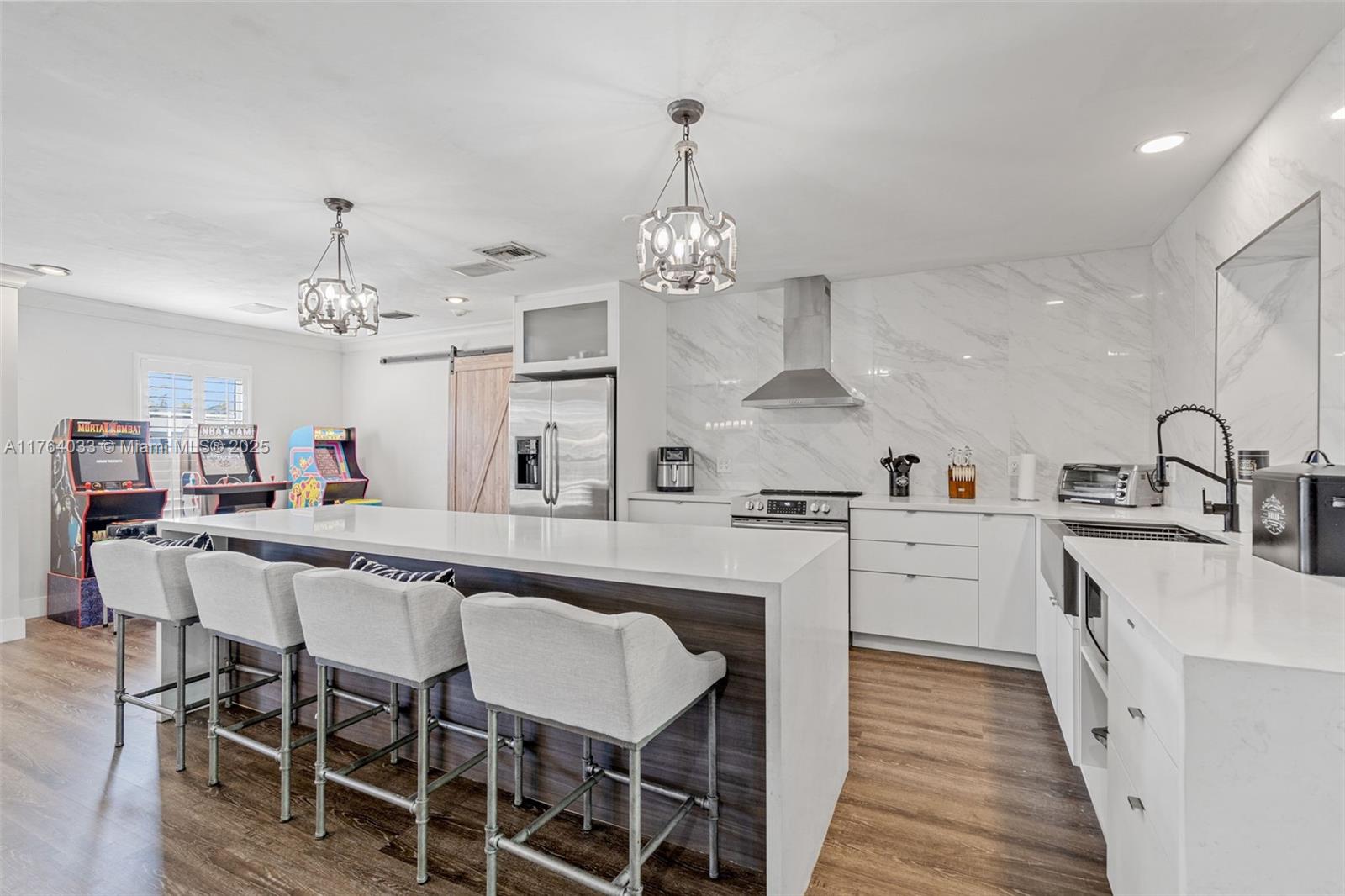 This beautiful 5-bed, 2-bath Cutler Bay home is a must-see! Nestled next to Whispering Pines, it features an open split floor plan, a spacious family room, built-in bar, and surround sound throughout. The kitchen was fully remodeled in 2022, and the master bath boasts modern updates. Enjoy impact windows, recessed lighting, vinyl flooring, and a built-in workstation. Step outside to a large yard with a shed for storage and a screened-in pool, perfect for relaxing or entertaining. Located on a cul-de-sac, with access to community events, top-rated schools, and just minutes from Black Point Marina.