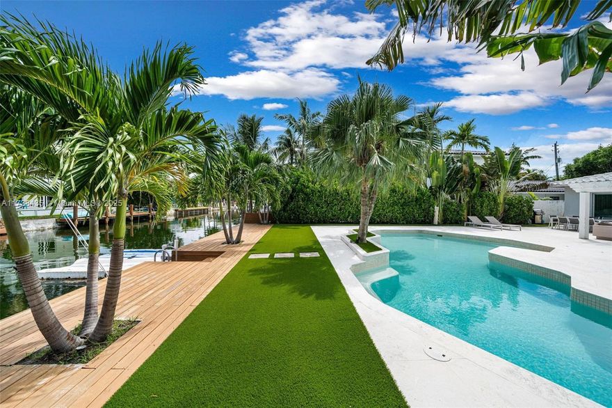 Nestled within the highly sought-after, guard-gated community of Biscayne Point, this charming 4-bedroom, 3-bathroom home boasts an open floor plan and a serene canal-front backyard. The outdoor space features lush landscaping, a plentiful front yard, and brand-new dock. Recently renovated, the backyard, front yard, and pool area showcase beautiful natural stone and tropical greenery, creating the perfect environment for relaxation, outdoor play and entertainment