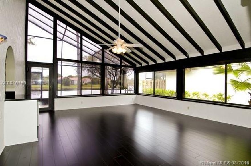 WOW! AMAZING! REMODELED one story 3/2 on cul de sac street, WIDE WATER VIEWS, UPDATED granite kitchen opens to great room, BONUS ROOM of 418 sq ft with vaulted beamed ceilings, screened & tiled PATIO overlooking lake, WOOD floors everywhere, special mold resistant ROOF 2007. Community pool. Maintenance includes lawn cutting & sprinklers. Ready to go. Steps to Town Center & shopping.