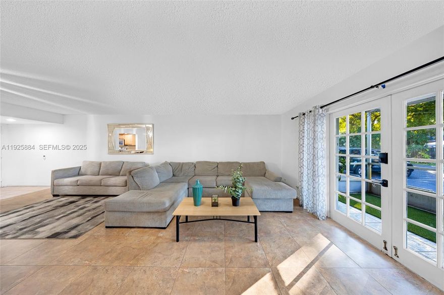 Spacious and inviting, this 2BR/2BA first-floor unit in Oak Path offers over 1,200 sqft of living space that feels like a single-family home! Featuring a huge kitchen with stainless steel appliances and a pass-through to the dining area, an oversized living room, and a primary suite with double closets and private bath; enjoy the convenience of full-size in-unit laundry, French doors leading to a charming screened patio, pet-friendly policies, and one covered parking space plus plenty of guest spots. The unit is ground level with a back porch that provides easy access for bringing in groceries, and accordion hurricane shutters, all within a well-maintained two-story building with a community pool!