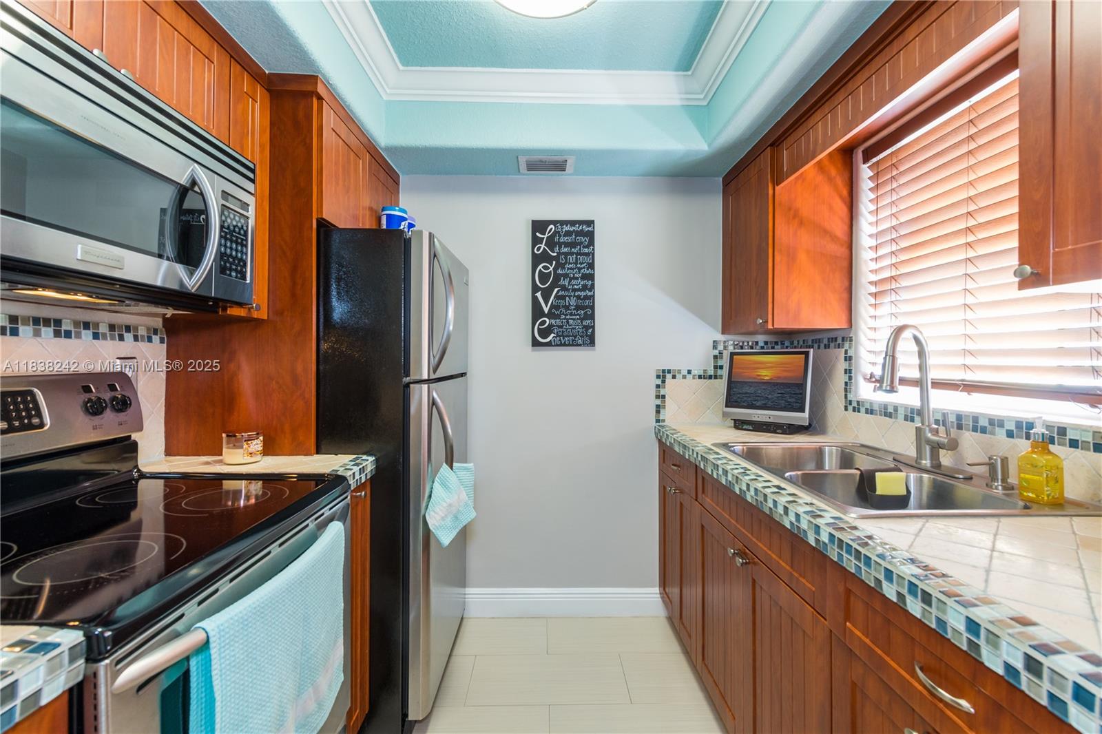 Immaculate 2-story condo in the gated community of Courtyards at Kendall. This updated unit features plantation shutters, a convenient guest bathroom on the first floor, and a bright, open layout. Community amenities include a pool, play area, laundry facilities, and ample parking. Prime location near shops, schools, and major highways. Move-in ready!