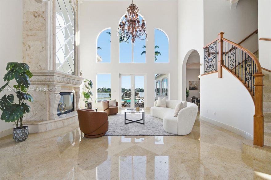 Mediterranean-inspired estate set on long, peaceful lakefront in the gated community of Windmill Reserve. This 6-bedroom, 7.5-bath residence offers more than 8,500 sqft of elegant living space with grand living room centered around marble fireplace. Chef’s kitchen features oversized center island, Sub-Zero refrigeration, gas cooktop, wall oven with warming drawer, breakfast area, and dedicated wine storage room. Spacious butler’s pantry and oversized laundry room sit nearby for added convenience. First floor includes billiard room with full bar, formal dining room, spacious family room, full guest bath, powder room, and additional first-floor office separate from private office located within primary suite. Primary suite occupies its own private wing with media room, sitting area, dual walk-in closets, dual powder rooms, spa-style bath, and direct access to outdoor areas. Upstairs, 4 additional ensuite bedrooms with walk-in closets,  open hallway overlooking living areas below to create a bright, connected second level. Outdoor living is designed for year-round enjoyment with long lake views, heated pool with water feature, and summer kitchen enhanced with roller shades for comfortable, shaded entertaining. Additional upgrades include full impact windows and doors, new electric wiring and circuit breaker, elevator, Savant sound system, and oversized 3 car garage. This residence blends space, function, and refined living in one of Weston’s most desirable luxury communities.