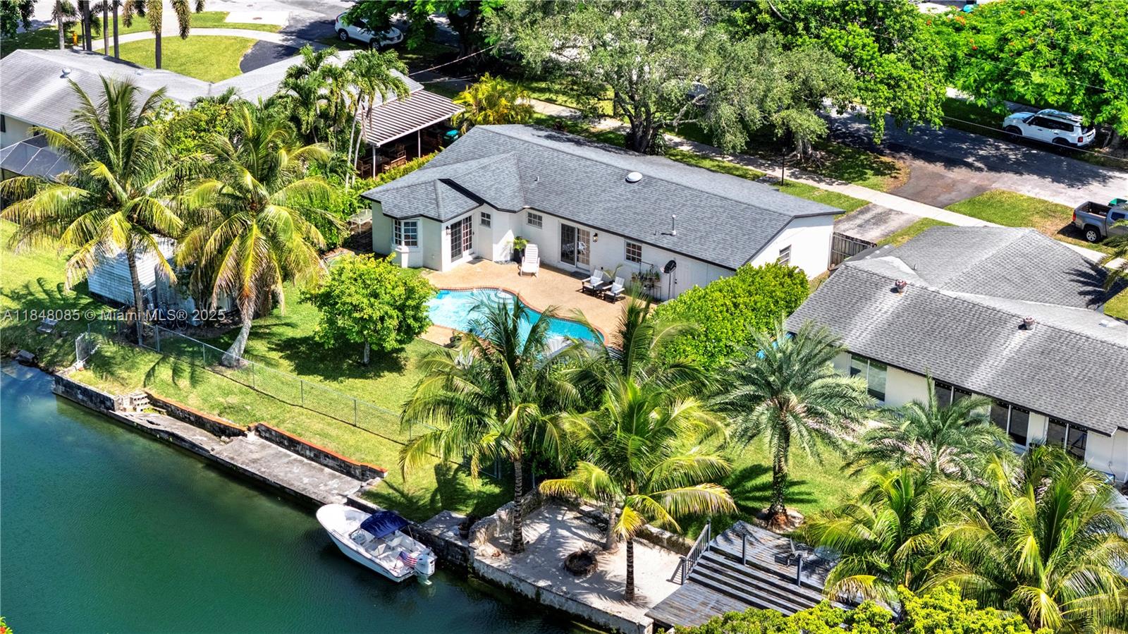 Every day is a vacation when you live on the water! This beautifully maintained home located on the Bel-Aire waterway features a large primary bedroom with renovated en-suite bath, walk in closet, and reading nook. The kitchen is well positioned to overlook a sparkling pool which can also be enjoyed from an outdoor covered gazebo. Sit on your dock to enjoy the water and breeze; kayak to enjoy the local wildlife including cranes, turtles, manatees and more; fish right in your backyard for peacock bass, snook and tarpon; or explore the miles of traversable water on your boat. Come see this gem and make it your forever home!