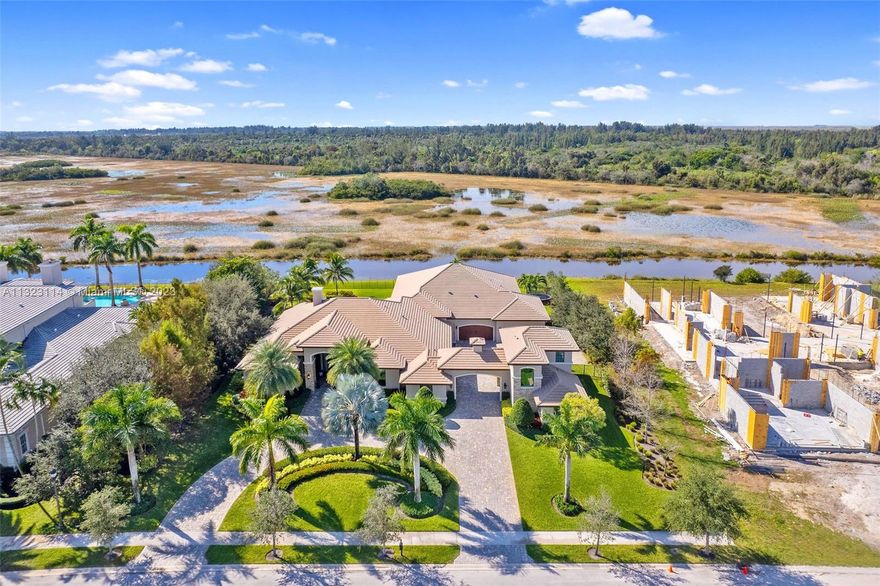 Elegant transitional estate offering unobstructed views of a nature preserve located in guard-gated Windmill Reserve. Car lovers-6-car garage w/lift! This timeless one-story villa features 5 BD/5.5BA + office + bonus room +media/gym. Separate two-story casita with 1 BD, 2 full BA, living/dining area, washer/dryer hook-ups, & private entrance. Huge family room opens to lavish kitchen equipped w/ Thermador appliances, double island w/ two-toned quarts countertops, two-toned self-closing cabinetry, butler’s pantry w/ wine cooler. Entertain in your living room w/wet bar with GE Monogram fridge & ice maker & TV.  Enjoy sunsets under expansive covered 1,600-Sq. Ft. patio w/6-seater bar. Saltwater pool/spa with seating ledge. Marble & porcelain plank flooring, interior/exterior surround sound.