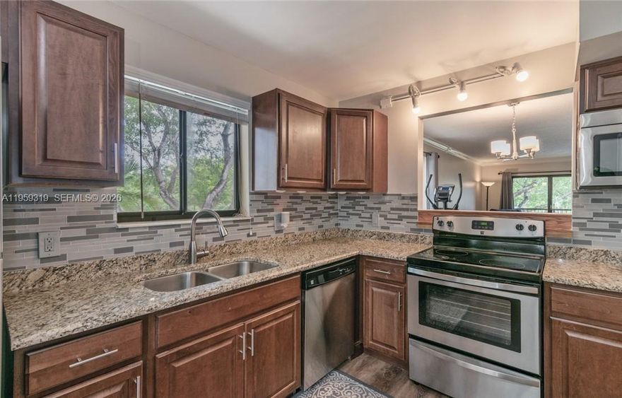 Beautifully renovated 2BR/2BA corner unit offering privacy and natural light. Features remodeled kitchen with stainless steel appliances, granite countertops and seating area, upgraded bathrooms, and elegant flooring throughout. New water heater, A/C approx. 6 yrs old, and washer/dryer in unit. Private balcony with tranquil canal and garden views. End unit with visitor parking directly in front. Includes access to Bonaventure Town Center Club with resort-style amenities. Located in A-rated school district with easy access to I-75, shopping, and dining *No rentals permitted in the first year of ownership*