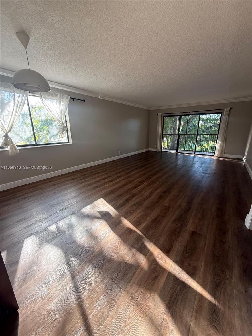 Beautifully renovated 2BR/2BA corner unit offering privacy and natural light. Features remodeled kitchen with stainless steel appliances, granite countertops and seating area, upgraded bathrooms, and elegant flooring throughout. New water heater, A/C approx. 6 yrs old, and washer/dryer in unit. Private balcony with tranquil canal and garden views. End unit with visitor parking directly in front. Includes access to Bonaventure Town Center Club with resort-style amenities. Located in A-rated school district with easy access to I-75, shopping, and dining *No rentals permitted in the first year of ownership* Seller Motivated*