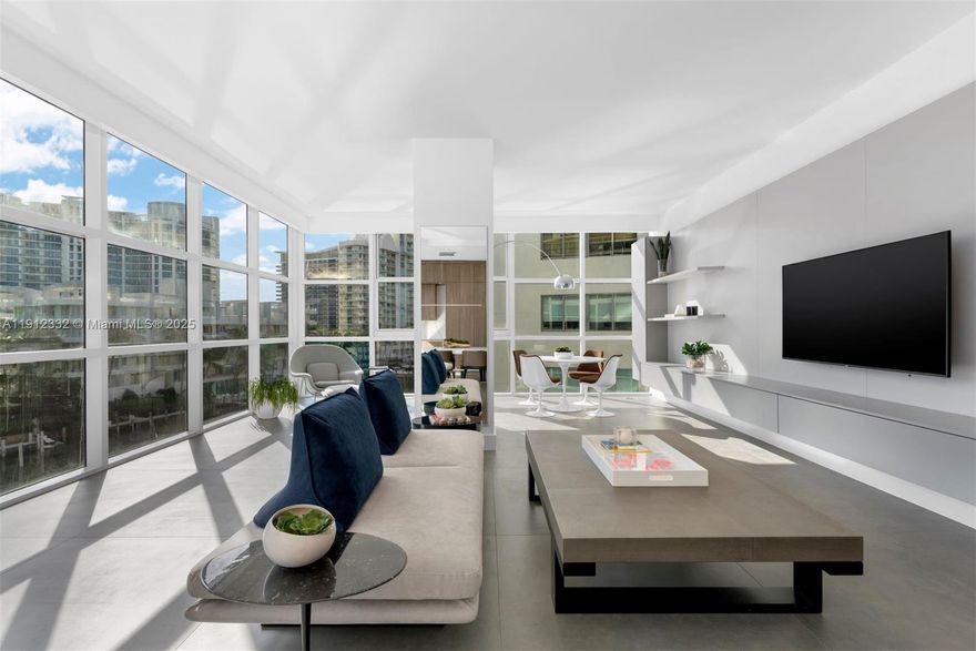 Experience the pinnacle of Miami Beach island living at Aqua at Allison Island, a private gated enclave where privacy meets resort style ease. This corner residence spans 2,752 square feet with 4 bedrooms and 4.5 baths, offering panoramic intracoastal and sunrise views through walls of glass that fill the interiors with natural light. Designed by a New York interior designer, the home features a Cabonnet kitchen designed in London and made in Italy, custom Misura Ema built ins, Porcelanosa powder room, and Opus Stone porcelain floors. Italian millwork and frameless doors create a seamless flow throughout. Enjoy dual pools, spa, fitness center, kids playroom, valet, concierge, and 24 hour security. Aqua at Allison Island where every day feels like a getaway. 1 or more image virtually staged