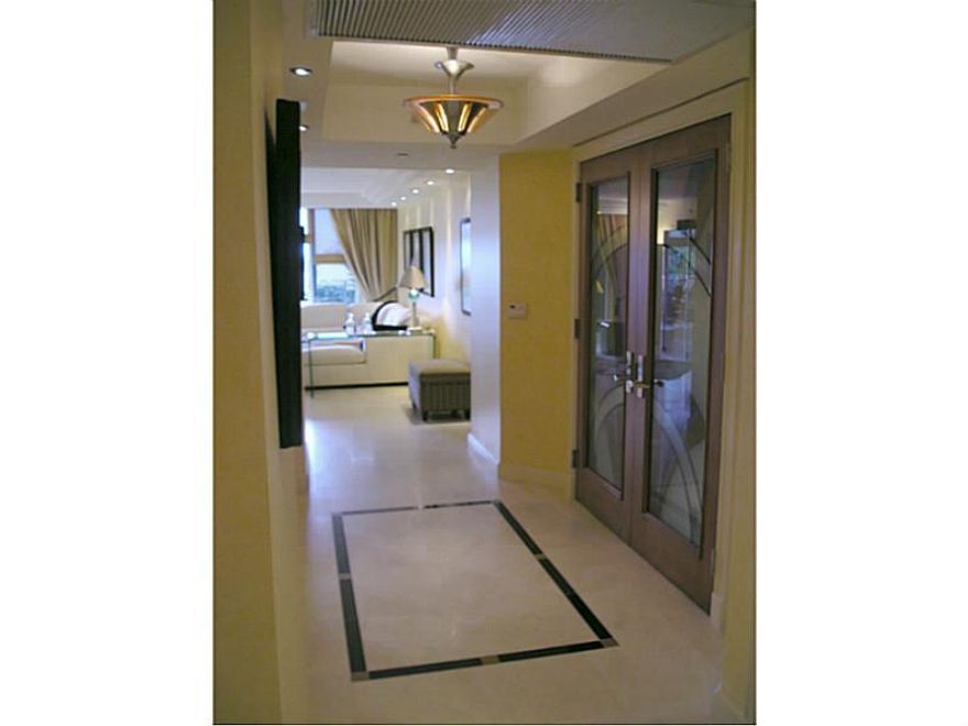 Step from your private elevator through dramatic Art Deco glass doors into spacious living, formal dining & 60' entertaining flow-thru.  Floorplan expands to 2 balconies, outstanding views of lake & Miami skyline.  Breakfast area & terrace for casual dini ng.  Sophisticated attention to fine details including travertine floors with marble inlay designs, stair-stepped soffits, designer lighting, custom cabinetry, thermostatic shower, bidet, Jacuzzi (cont'd in attachment).