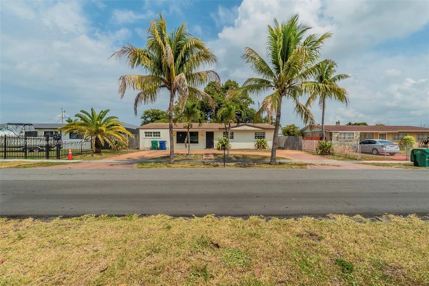 Charming home with great curb appeal, featuring mango and avocado trees! A welcoming driveway leads to a wood-fenced yard. Inside, the living and dining area opens to a patio and backyard. The kitchen boasts white cabinets, stainless steel appliances, and a laundry room. To the east, find a bathroom with a standing shower, secondary bedrooms with tile flooring. On the west side, an additional space serves as a bedroom or office. A must-see home with character and versatility!